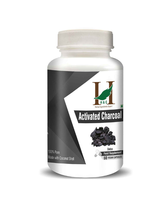 Bottle of activated charcoal supplement on a white background